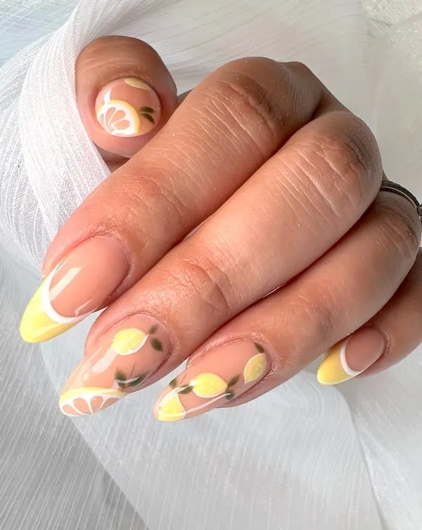 Lemon nail art and yellow French tip almond nails.