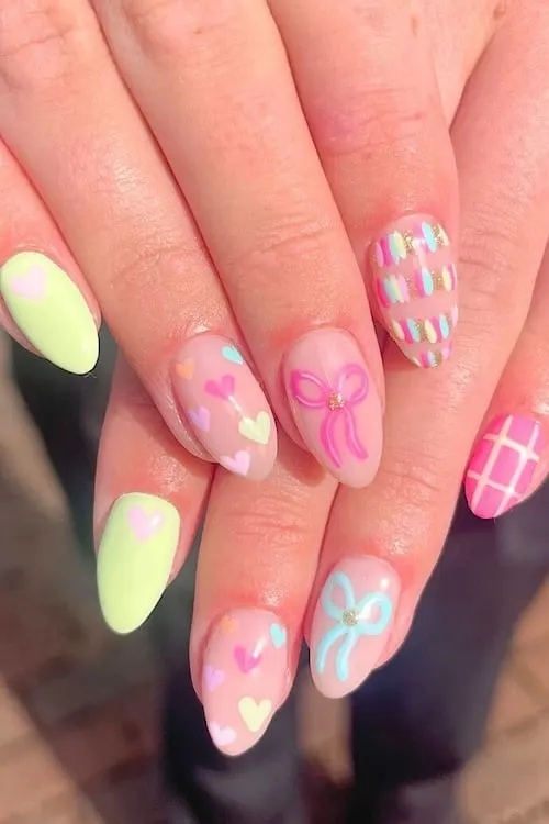 Pastel bows and hearts nails.