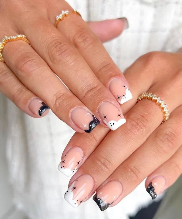 Black and white stars French tip nails.