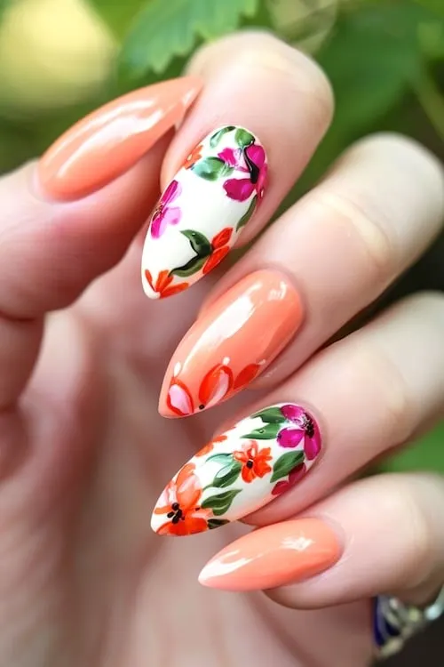 Floral peach almond-shaped May nails.