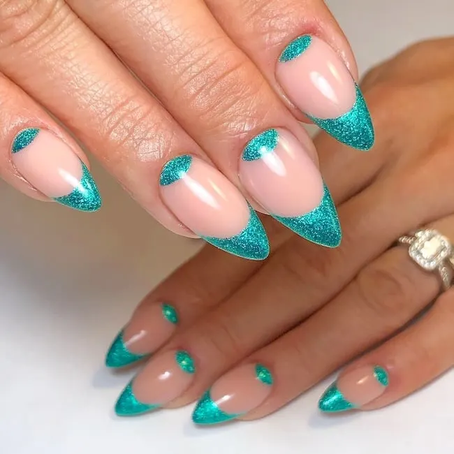 Ocean glitter French tip nails.