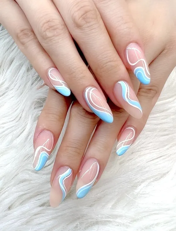 Baby blue swirl almond nails.