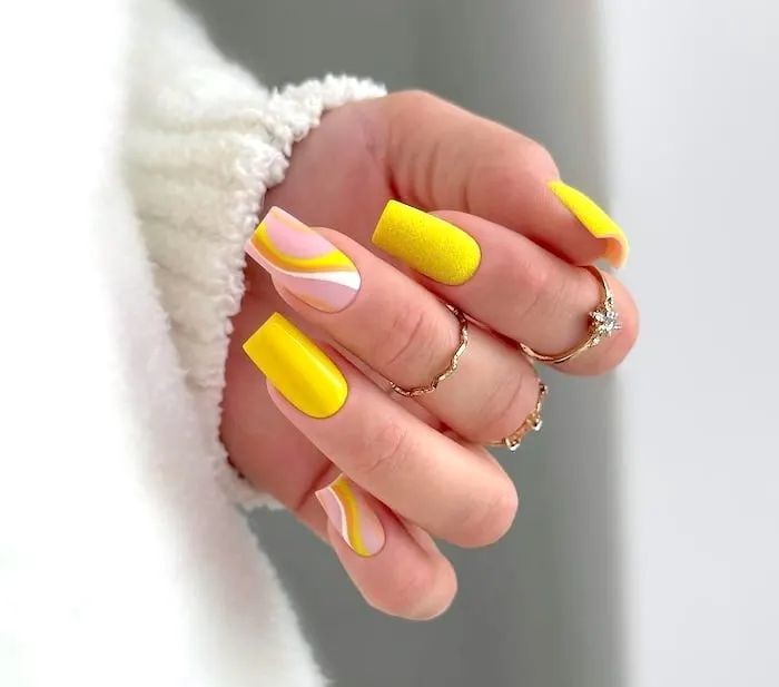 Bright yellow May nails.