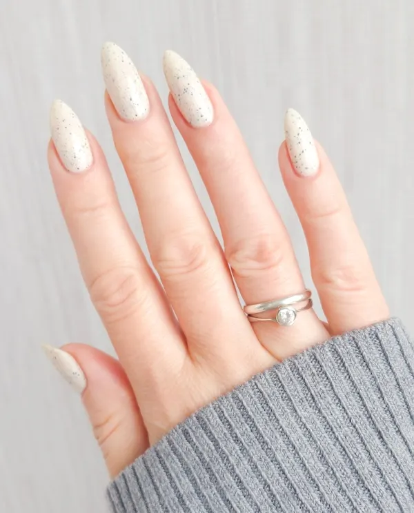 Speckled eggshell almond nails.