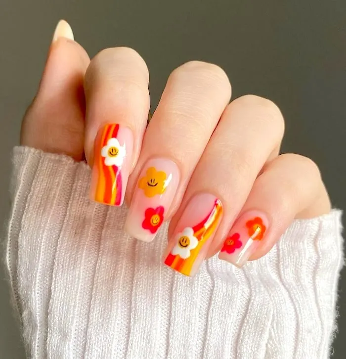 Floral orange neon nails.