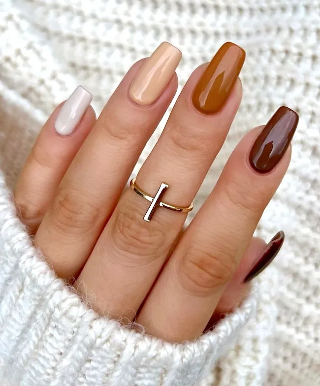 Multi-shaded nude nails.