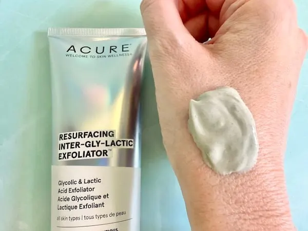 Acure Resurfacing Inter-Gly-Lactic Exfoliator, flatlay next to sample on hand.