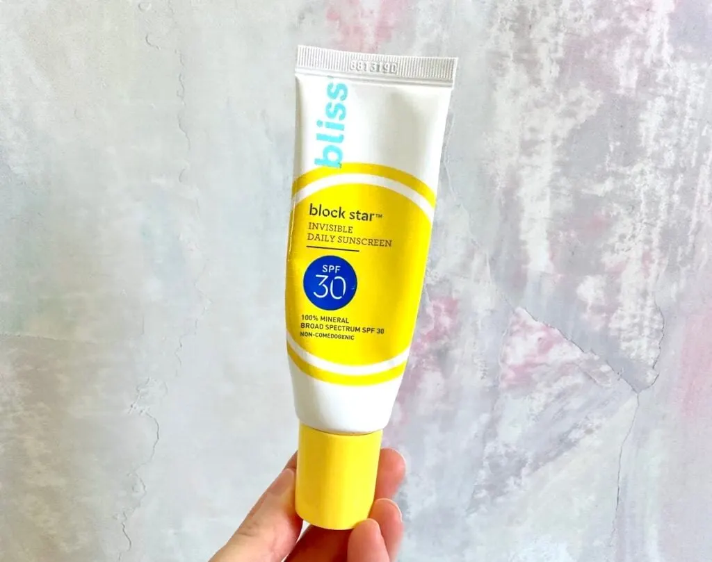 Bliss Block Start invisible Daily Sunscreen SPF 30, handheld.