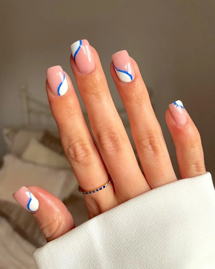 Blue white swirl nails.