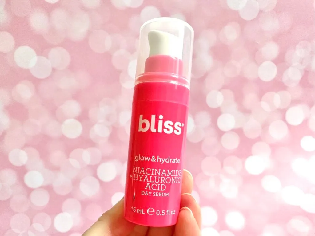 Bliss Glow & Hydrate Niacinamide + Hyaluronic Acid Day Serum, handheld.