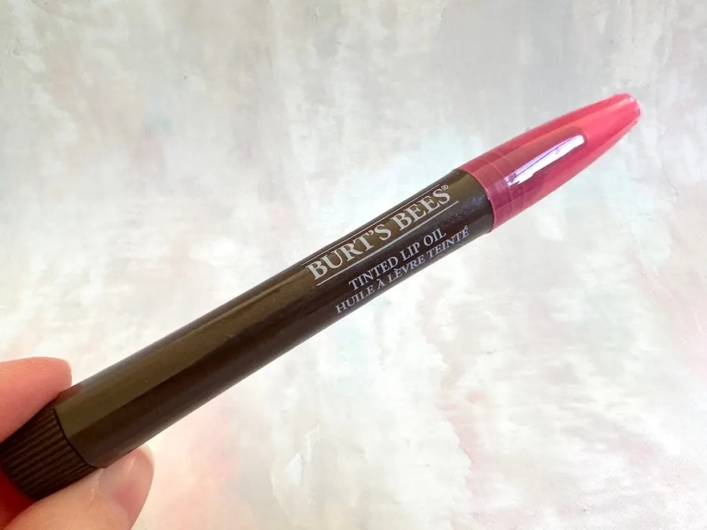 Burt's Bees Tinted Lip Oil in the shade Whispering Orchid, handheld.