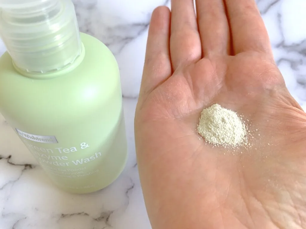 Wishtrend Green Tea & Enzyme Powder Wash powder sampled on palm of hand.