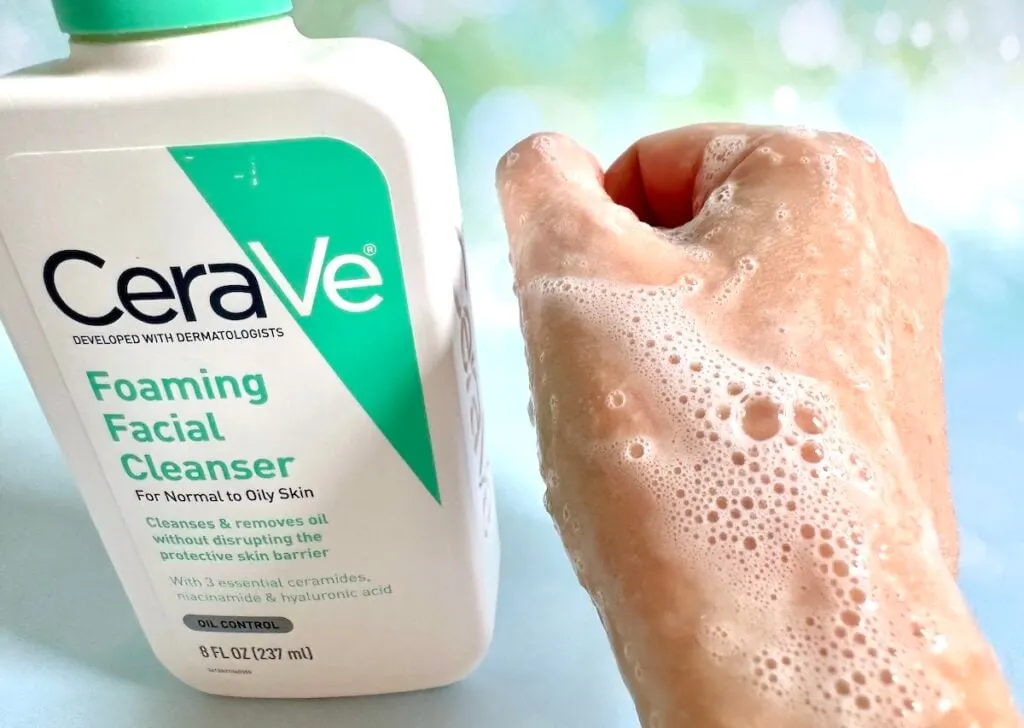 CeraVe Foaming Facial Cleanser bottle next to foam sample on hand.