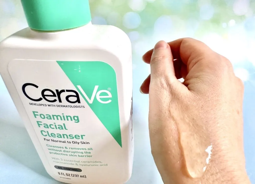 CeraVe Foaming Facial Cleanser bottle next to gel sample on back of hand.