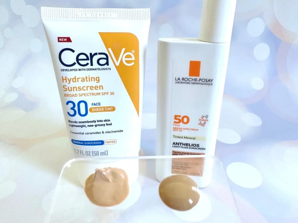 CeraVe Hydrating Mineral Sunscreen SPF 30 Face Sheer Tint vs La Roche-Posay Anthelios Tinted Sunscreen SPF 50, bottles next to samples on clear plastic spatula.