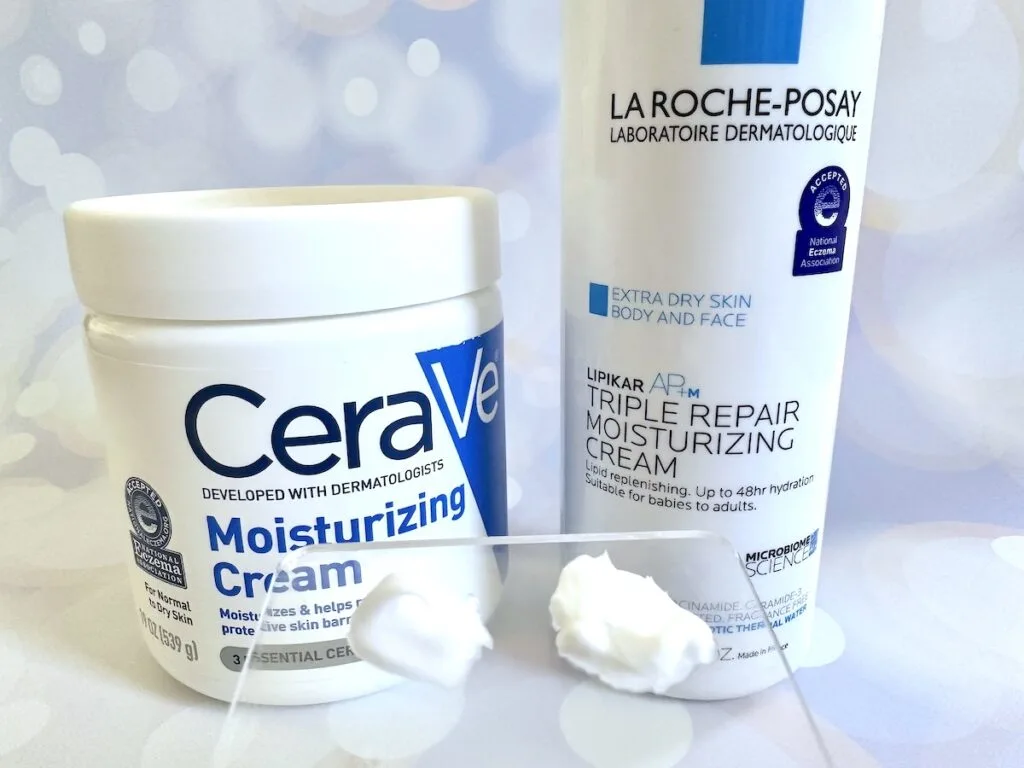 CeraVe Moisturizing Cream vs La Roche-Posay Lipikar AP+M Triple Repair Moisturizing Body Cream, next to samples on clear cosmetic spatula.