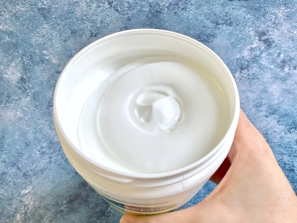 Cetaphil Moisturizing Cream, open tub, handheld.