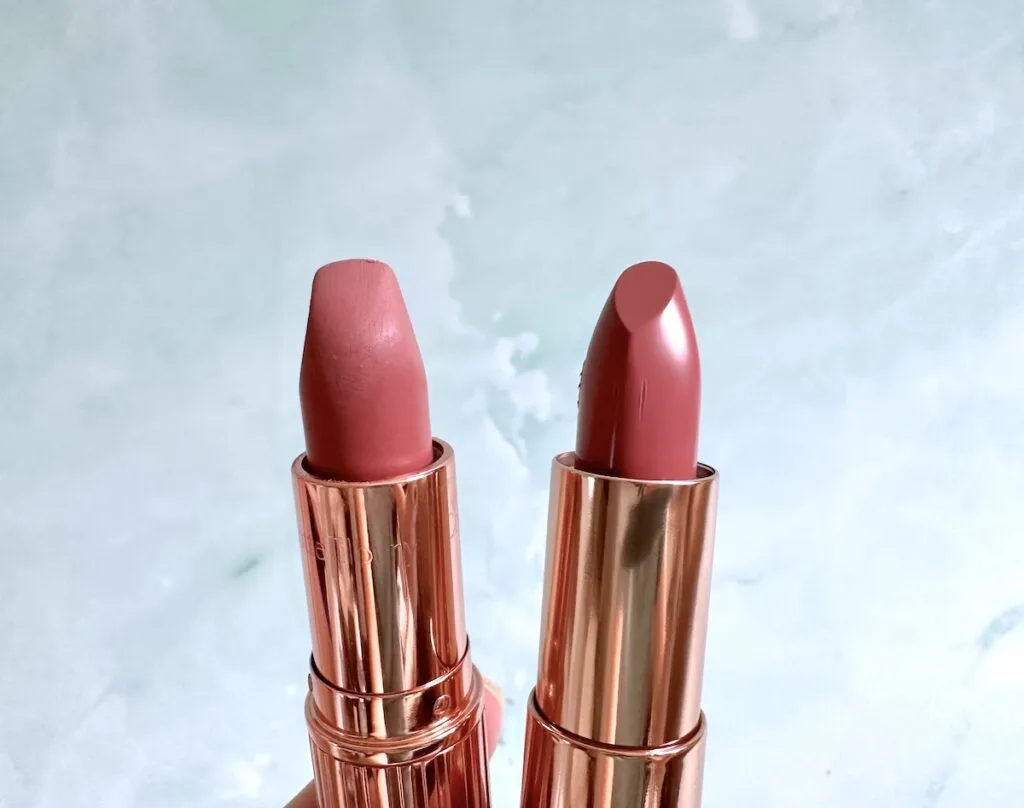 Charlotte Tilbury Pillow Talk Lipstick and Flower Beauty Perfect Pout Moisturizing Lipstick in Buttercup, handheld.