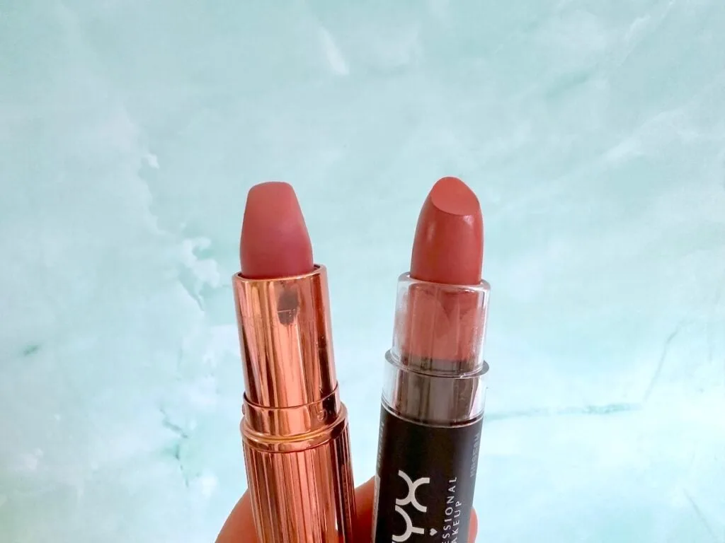 Charlotte Tilbury Pillow Talk Lipstick and NYX Matte Lipstick in Euro Trash, handheld.