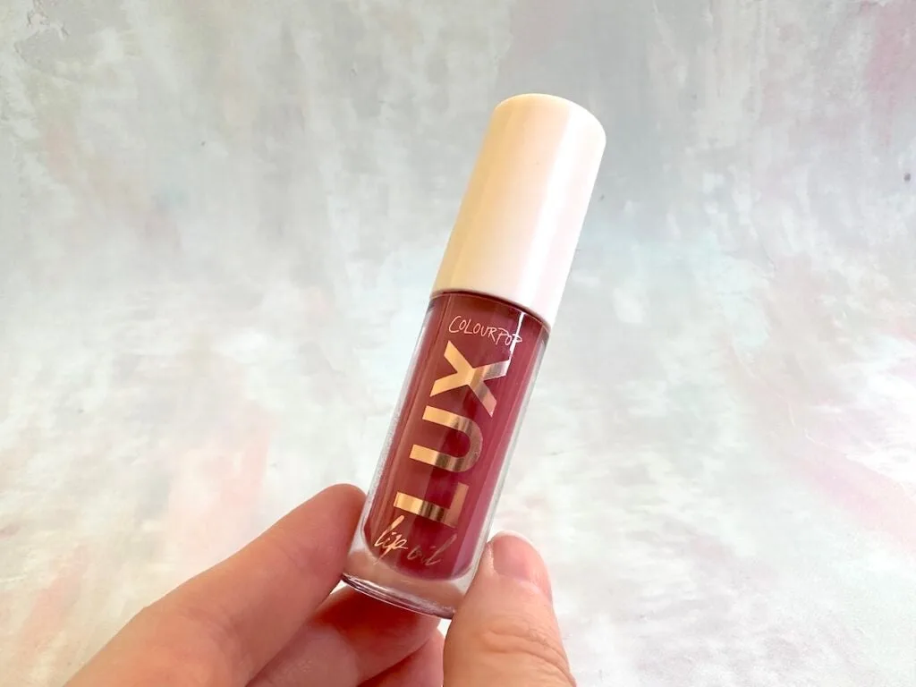 ColourPop Lux Lip Oil in the shade Bengal, handheld..