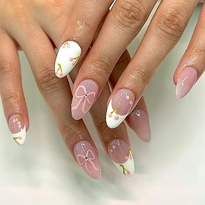 Pink and white French tip coquette nails.