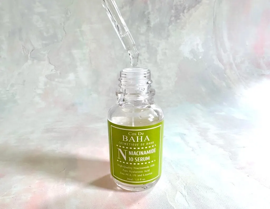 Cos De Baha Niacinamide 10% + Zinc PCA 1% Serum, open bottle with dropper applicator.