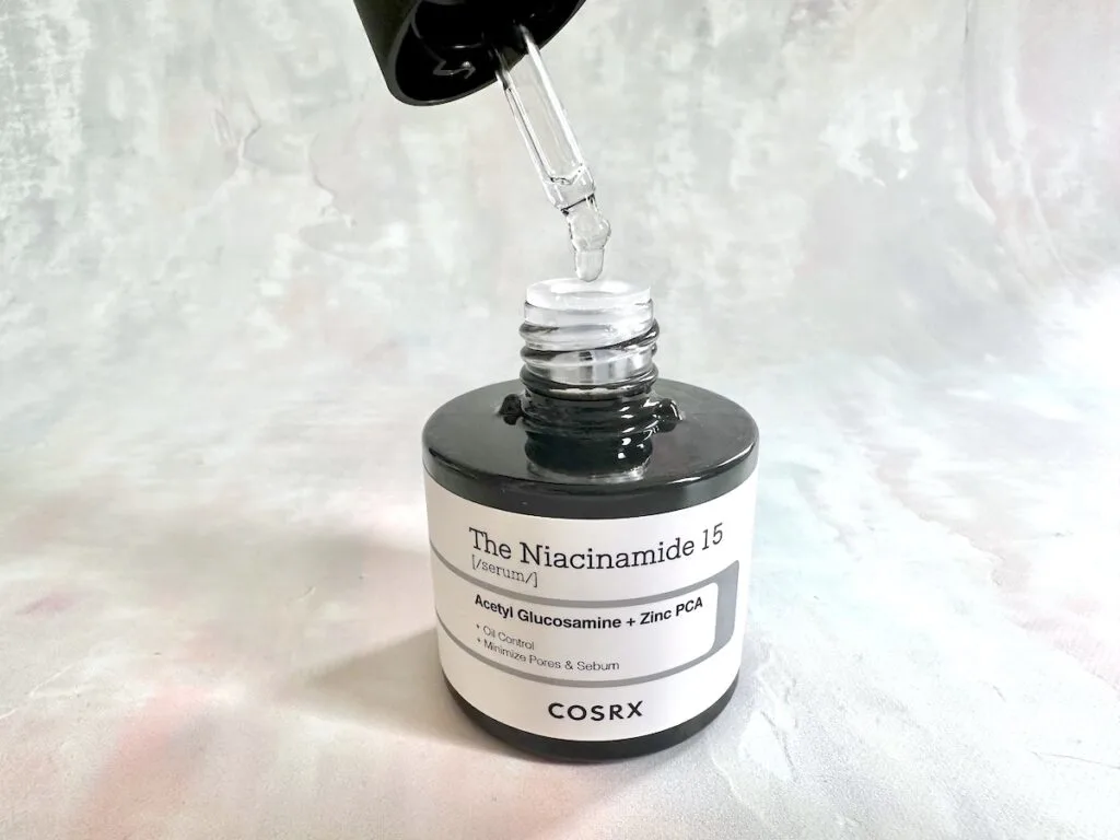 COSRX The Niacinamide 15 Serum, open bottle with dropper applicator.