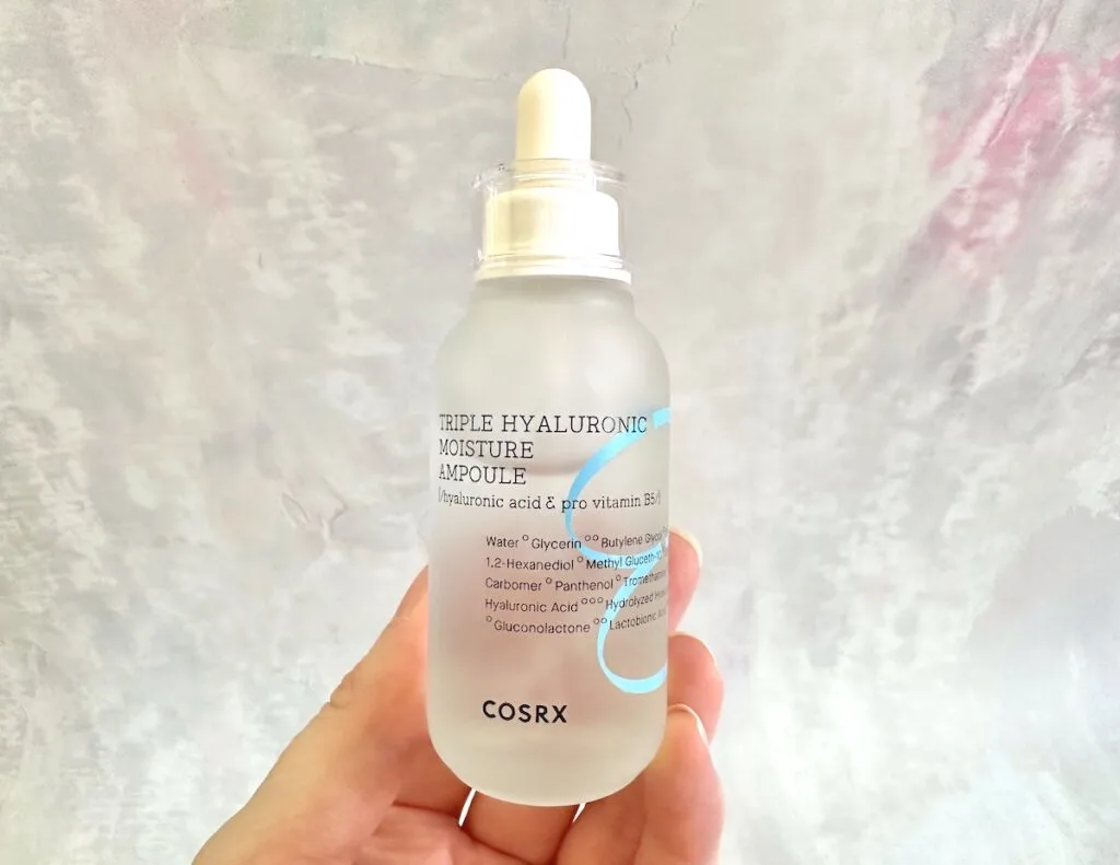 COSRX Hydrium Triple Hyaluronic Moisture Ampoule, handheld.