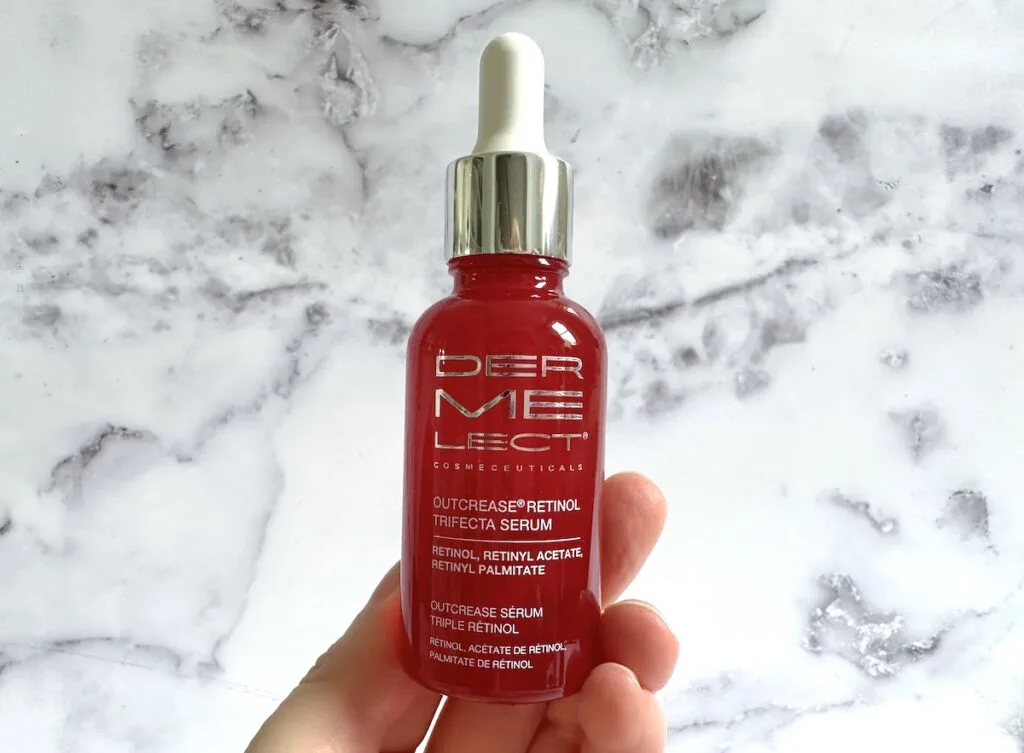 Dermelect Outcrease Retinol Trifecta Serum, handheld.