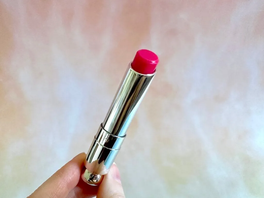 Dior Addict Lip Glow in the shade Raspberry, handheld.