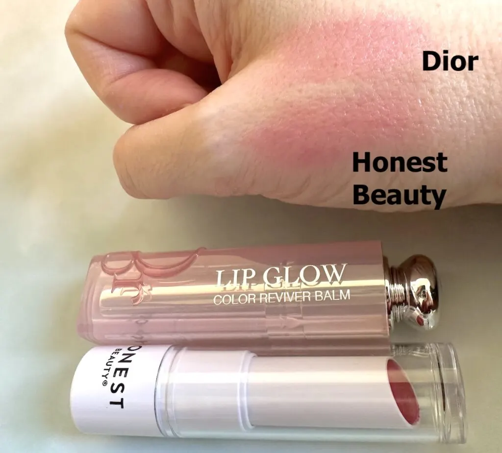 Dior Lip Glow in Raspberry and Honest Beauty Tinted Lip Balm in the shade Dragon Fruit sampled on hand.