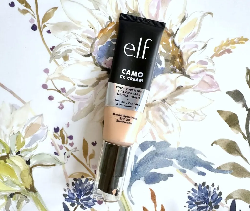 E.l.f. Camo CC Cream in the shade Light 210 N, flatlay on floral background.