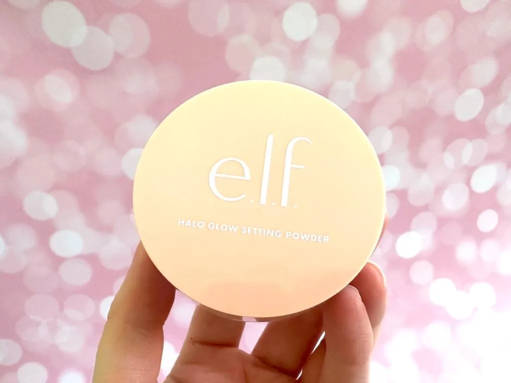 e.l.f. Halo Glow Loose Setting Powder in the shade Light, handheld.