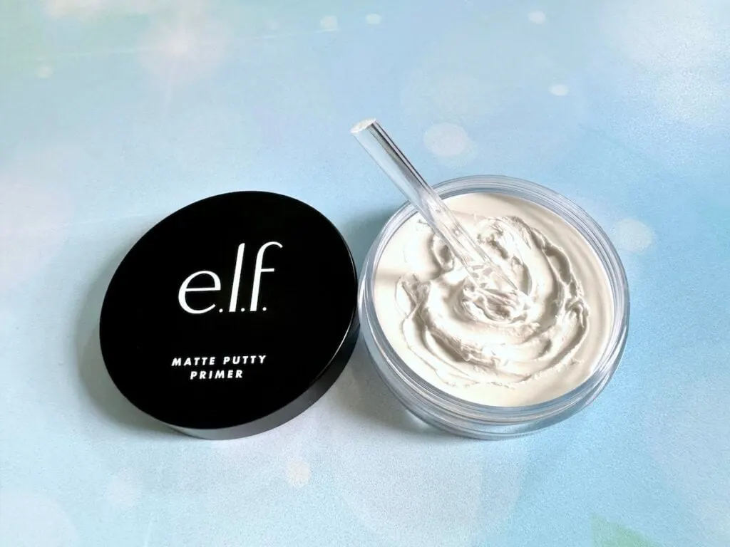 e.l.f. Matte Putty Primer jar open with clear cosmetic spatula in putty primer.