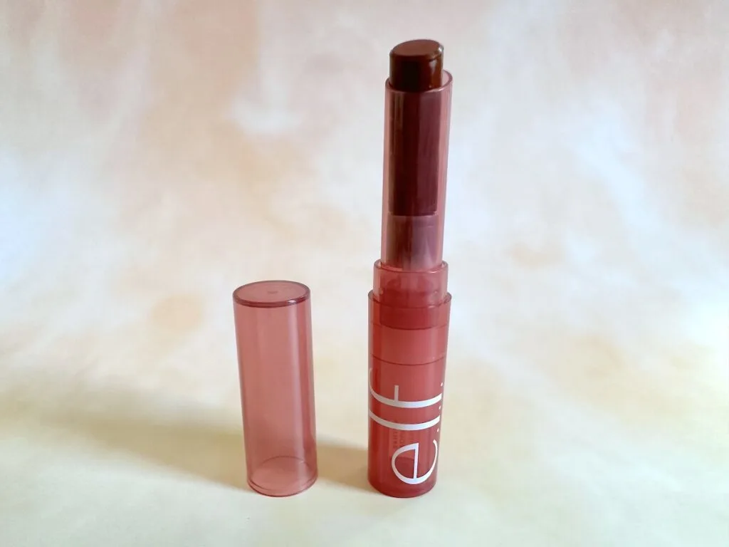 e.l.f. Sheer Slick Lipstick in Black Cherry, open lipstick tube with lid.