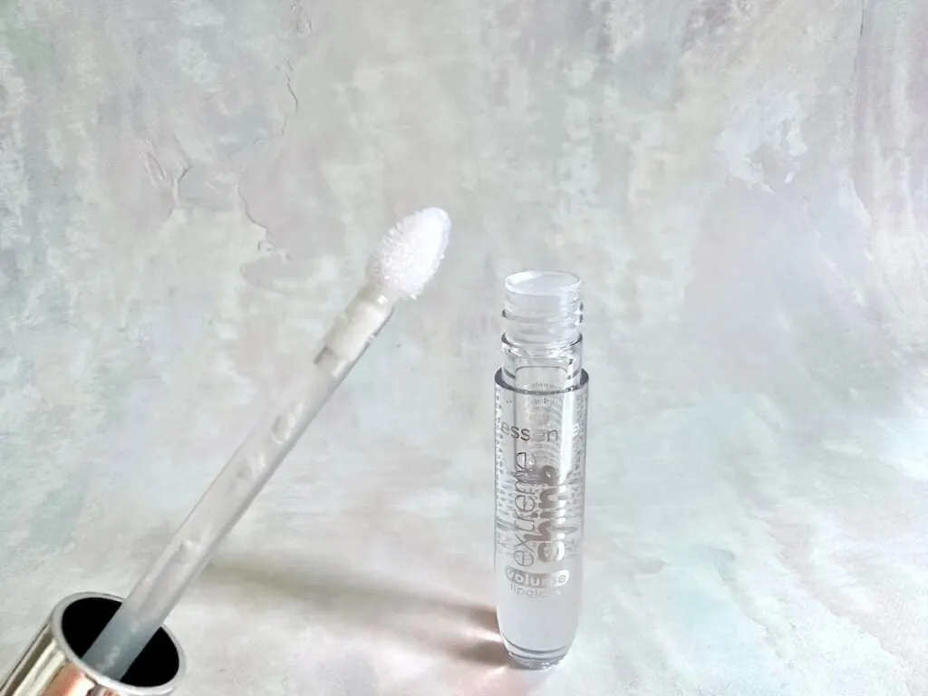 Essence Extreme Shine Volume Lip Gloss in the shade Crystal Clear, open tube with applicator wand.