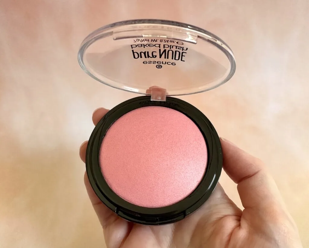 Essence Pure Nude Baked Blush in the shade Cool Coral, handheld.