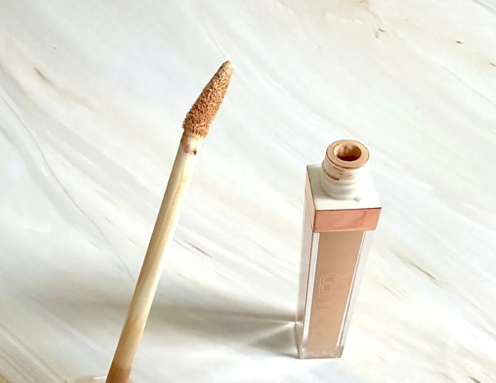 Flower Beauty Light Illusion Full Coverage Concealer in the shade Light, open tube with angled applicator wand.