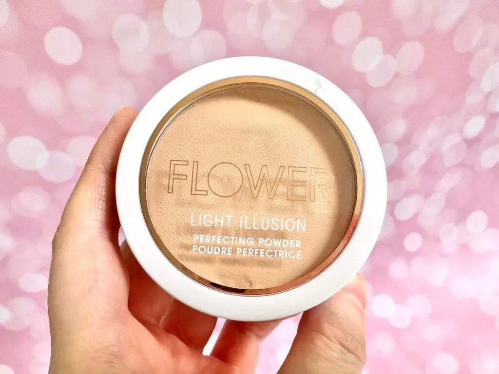 Flower Beauty Light Illusion Perfecting Powder in the shade Beige, handheld.