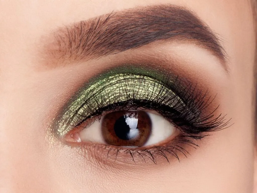 Metallic green and brown eyeshadow on brown eye.