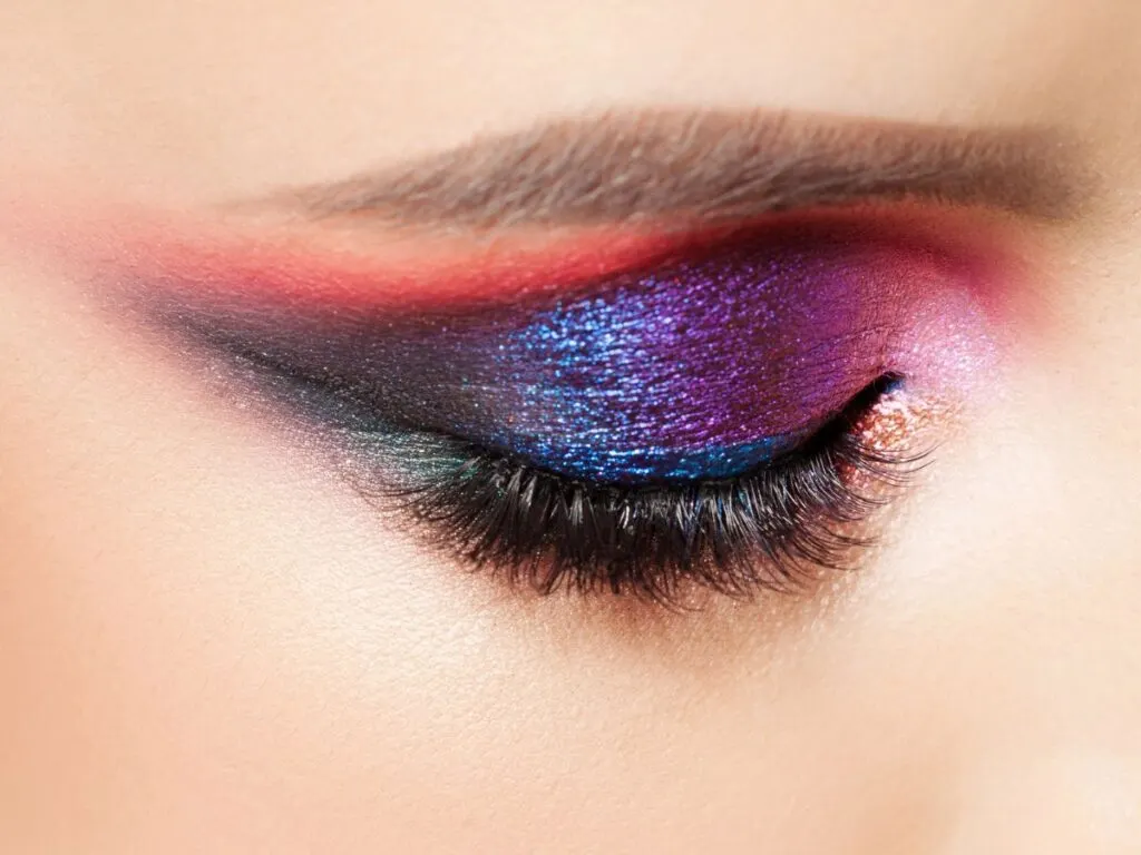 Multi-shaded glitter eyeshadow on closed eye.