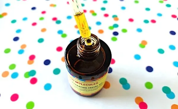 Good Molecules Ultra-Hydrating Facial Oil with dropper on colorful dot background