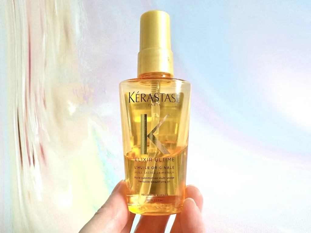 Kerastase Elixir Ultime Hair Oil, handheld.