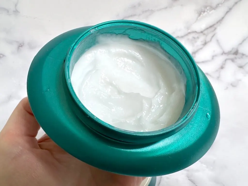 Kerastase Resistance Masque Therapiste Hair Mask open jar handheld.