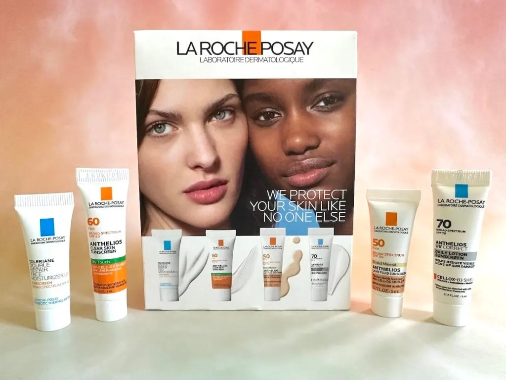 La Roche Posay Anthelios Sunscreen 4 Piece Sampler box beside four sample sunscreen bottles.