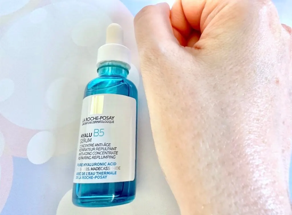 La Roche-Posay Hyalu B5 Serum, flatlay of bottle next to sample absorbed into hand.