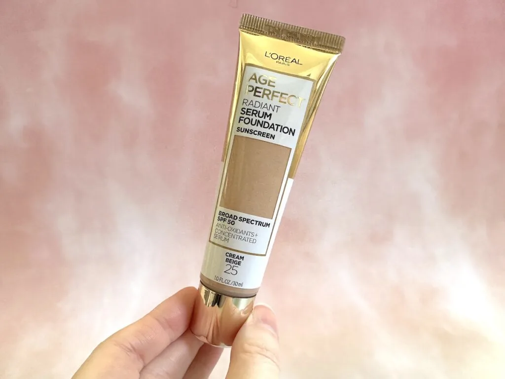 L'Oreal Paris Age Perfect Radiant Serum Foundation With SPF 50 handheld in the shade Cream Beige.