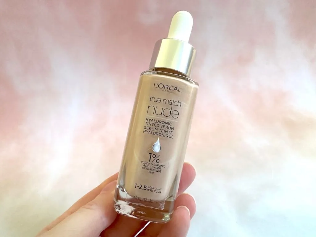 L'Oreal True Match Nude Hyaluronic Tinted Serum Foundation handheld in the shade Rosy Light.