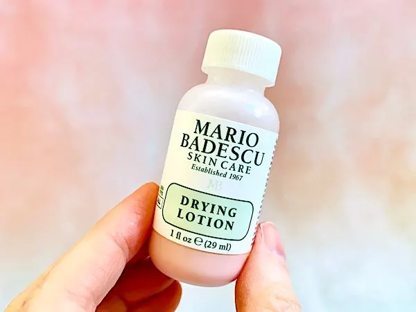 Mario Badescu Drying Lotion held by fingers