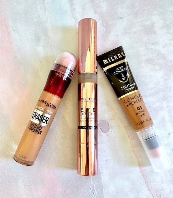 Charlotte Tilbury Contour Wand dupes from Maybelline, Makeup Revolution and Milani, flatlay.